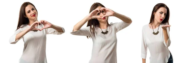 Pretty young girl making a heart with her hands — Stock Photo, Image