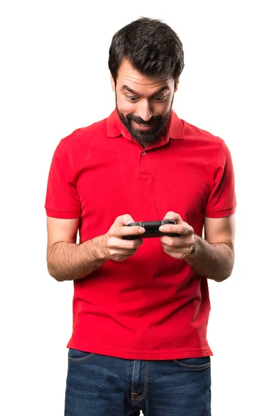 Glücklich schöner junger Mann spielt Videospiele über isolierten weißen — Stockfoto