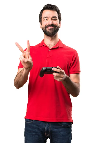 Glück gut aussehender junger Mann spielt Videospiele über isolierten weißen — Stockfoto