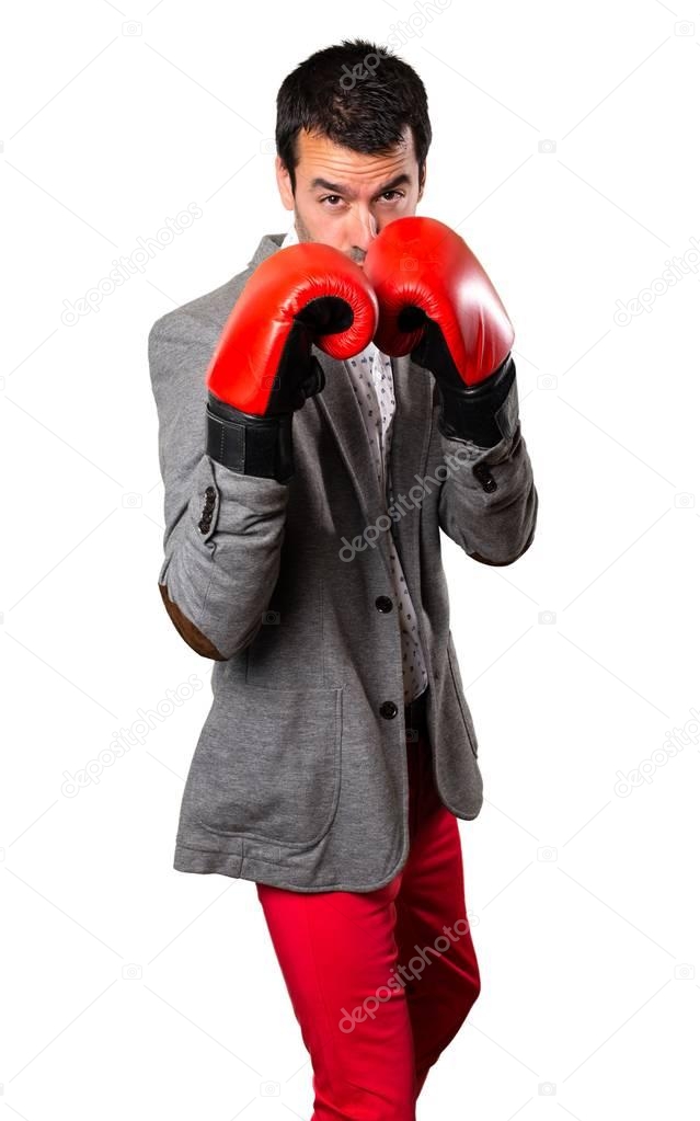 Handsome man with boxing gloves on isolated background