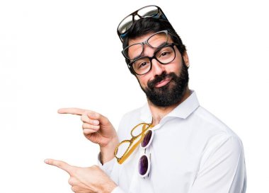 Handsome man with glasses pointing to the lateral clipart