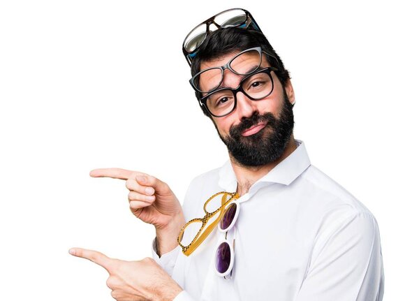 Handsome man with glasses pointing to the lateral