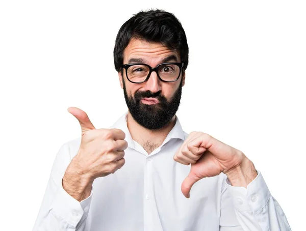 Handsome man with glasses making good-bad sign — Stock Photo, Image