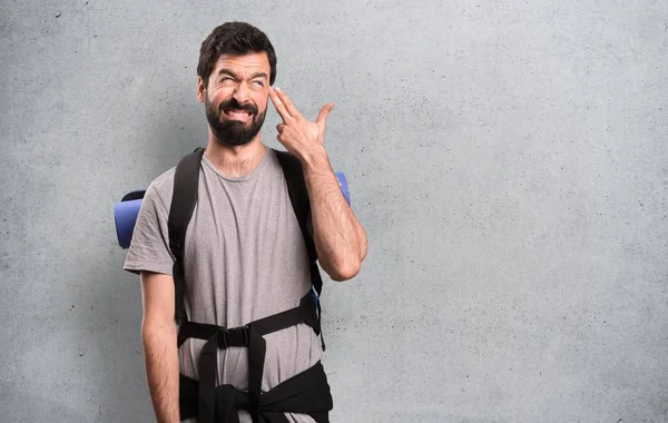 Stilig backpacker gör självmord gest på texturerat bakgrund — Stockfoto