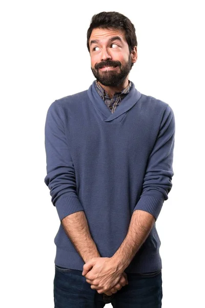 Schöner brünetter Mann mit Bart macht unwichtige Geste auf weißem Hintergrund — Stockfoto