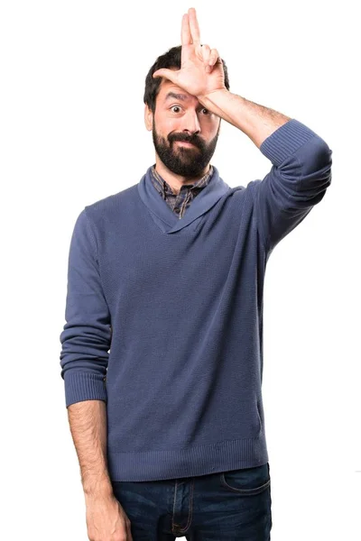 Красива брюнетка чоловік з бородою робить знак невдахи на білому тлі — стокове фото