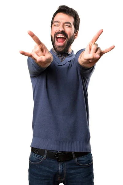 Handsome brunette man with beard making horn gesture on white background — Stock Photo, Image