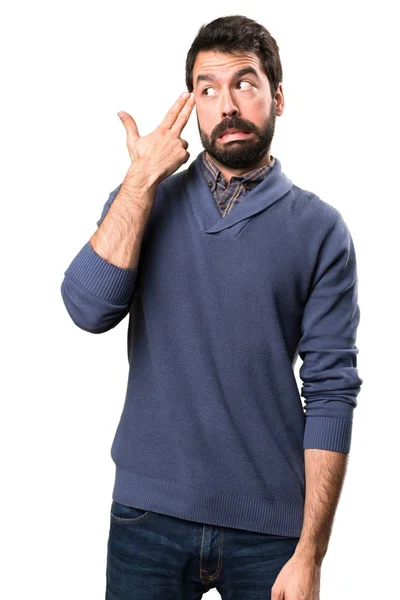 Knappe brunette man met baard maken zelfmoord gebaar op witte achtergrond — Stockfoto