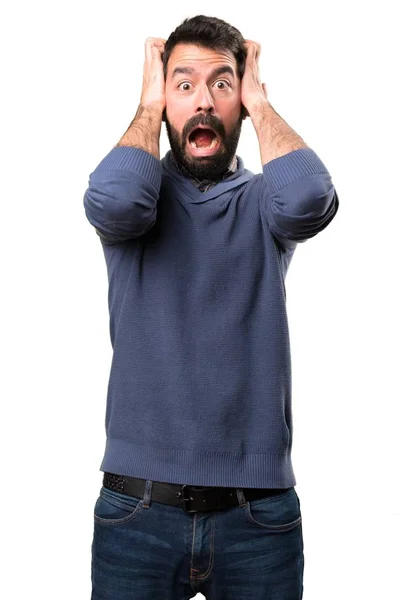 Frustriert schöner brünetter Mann mit Bart auf weißem Hintergrund — Stockfoto