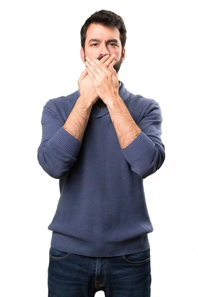 Handsome brunette man with beard covering his mouth on white background — Stock Photo, Image