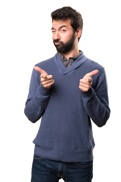 Handsome brunette man with beard pointing to the front on white background — Stock Photo, Image