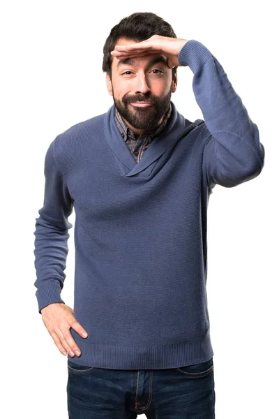 Handsome brunette man with beard showing something on white background — Stock Photo, Image