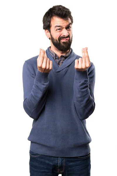 Bonito morena homem com barba fazendo gesto de dinheiro no fundo branco — Fotografia de Stock