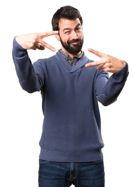 Handsome brunette man with beard making victory gesture on white background — Stock Photo, Image