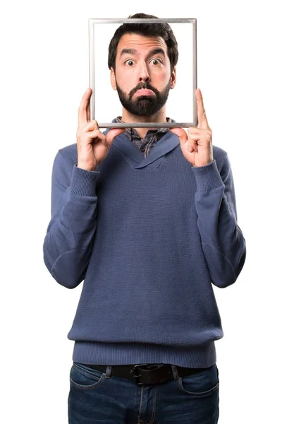 Sad Handsome brunette man with beard with framework on white background — Stock Photo, Image