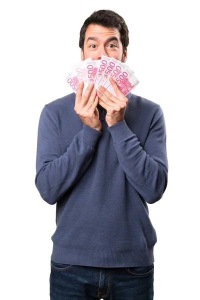 Guapo morena hombre con barba tomando un montón de dinero sobre fondo blanco — Foto de Stock