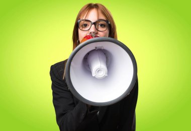 Bir megafon renkli arka plan üzerinde tutan genç iş kadını