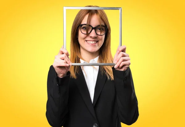 Young business woman with framework on colorful background — Stock Photo, Image