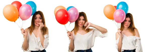 Set de Hermosa jovencita sosteniendo un globo y haciendo mal sig — Foto de Stock