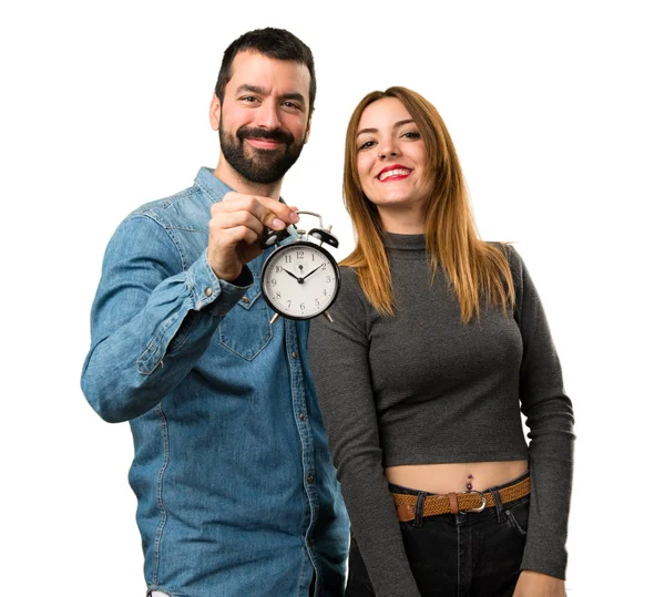 Man and woman holding vintage clock — Stock Photo, Image