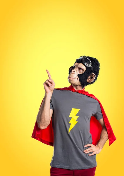 Superhero monkey man pointing up