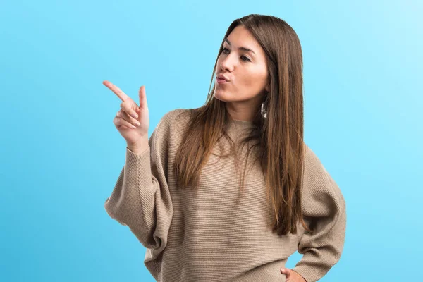 Girl thinking and pointing up — Stock Photo, Image