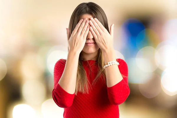 Young girl covering her eyes over isolated white background — Stock Photo, Image