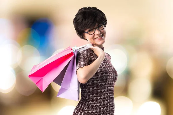 Žena s mnoha nákupní tašky — Stock fotografie