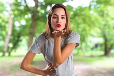 Kadın parkta bir öpücük gönderme