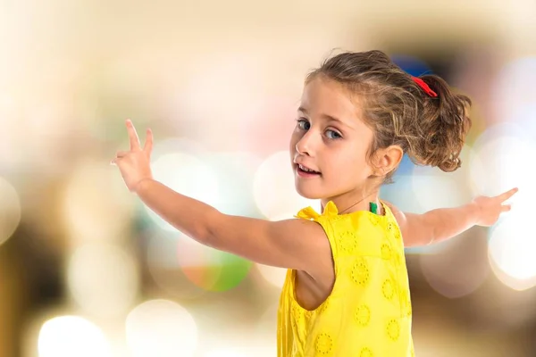 Blonde little girl dancing over white background — Stock Photo, Image