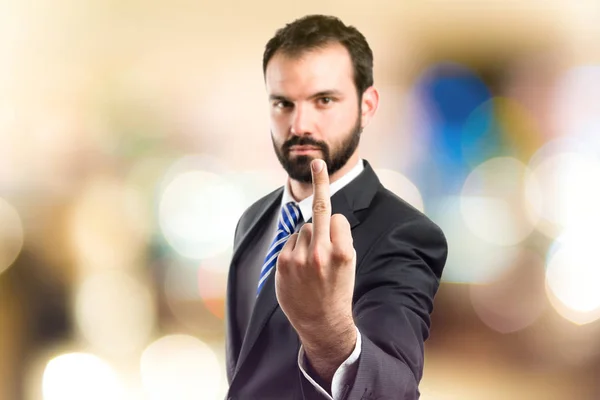 Joven hombre de negocios haciendo el signo de cuerno sobre fondo blanco —  Fotos de Stock