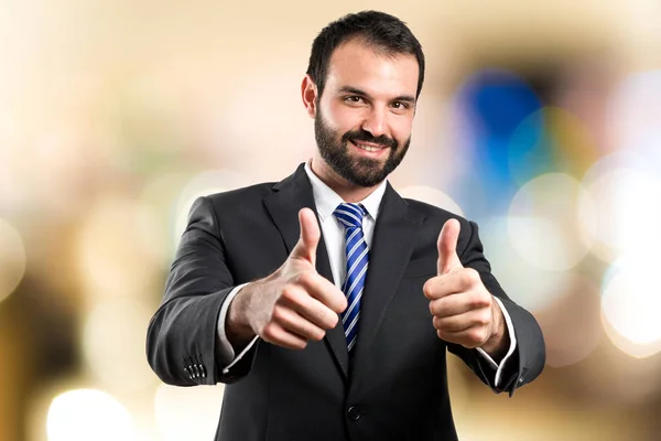 Young businessman getting OK over white background — Stock Photo, Image