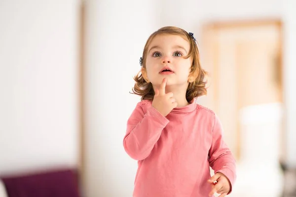 Little girl thinking over white background — Stock Photo, Image