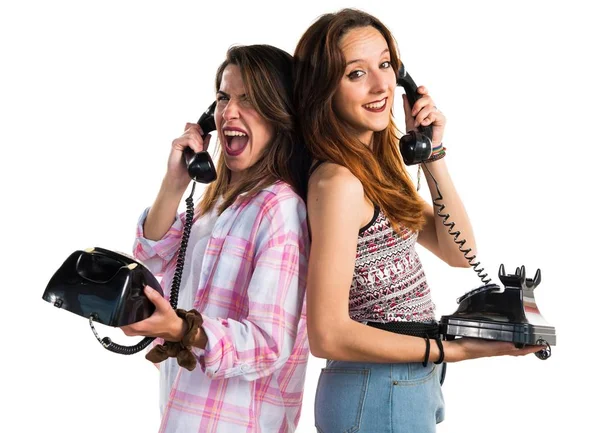 Friends talking to vintage phone — Stock Photo, Image