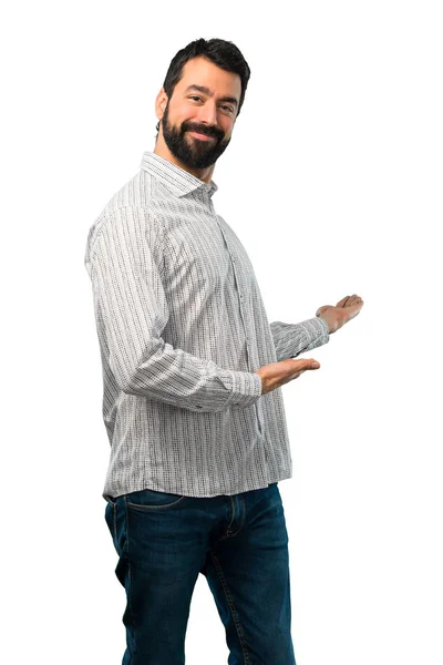 Przystojny mężczyzna z brodą, prezentując i zapraszając do kontaktu — Zdjęcie stockowe