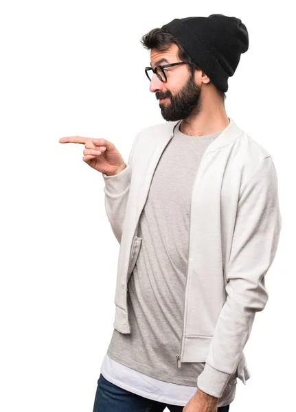 Hipster man pointing to the lateral on white background — Stock Photo, Image