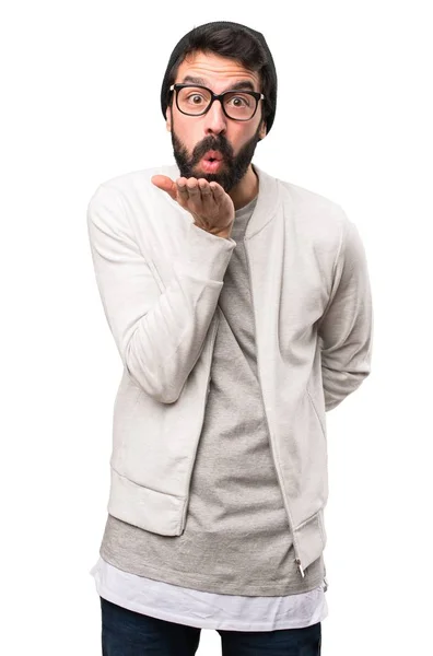 Hipster man sending a kiss on white background — Stock Photo, Image