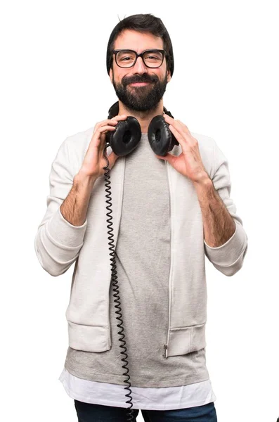 Happy Hipster man listening music on white background — Stock Photo, Image