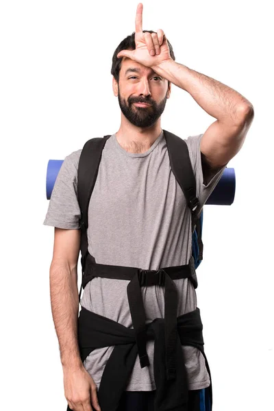 Handsome backpacker making loser sign on white background — Stock Photo, Image