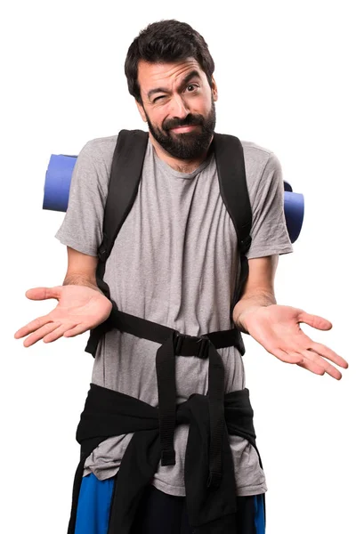 Handsome backpacker making unimportant gesture on white backgrou — Stock Photo, Image