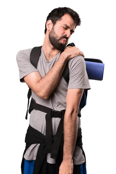 Handsome backpacker with shoulder pain on white background — Stock Photo, Image