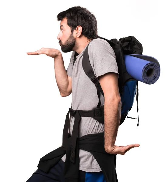Handsome backpacker dancing on white background — Stock Photo, Image