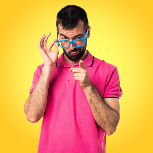 Homem com roupas coloridas mostrando algo — Fotografia de Stock