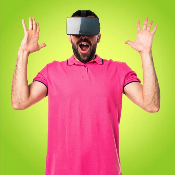 Man with colorful clothes using VR glasses — Stock Photo, Image