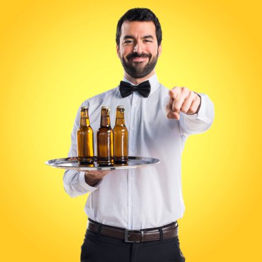 Garson bira şişeleri önüne işaret tepsi ile