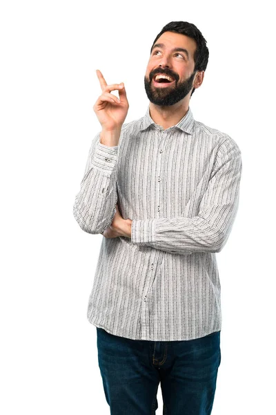 Knappe man met baard permanent en denken van een idee — Stockfoto