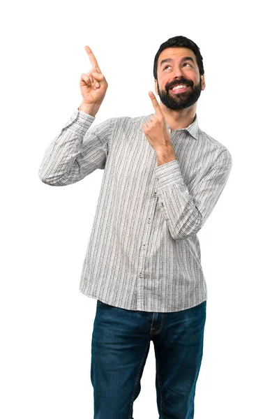 Hombre guapo con barba señalando con el dedo índice una gran i — Foto de Stock