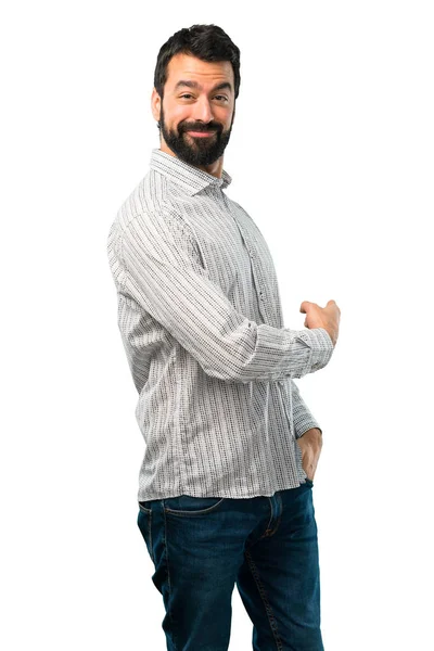 Hombre guapo con barba apuntando hacia atrás con el dedo índice — Foto de Stock