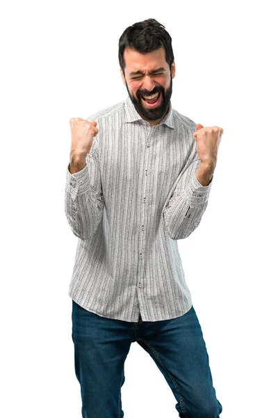 Homem bonito com barba celebrando uma vitória — Fotografia de Stock