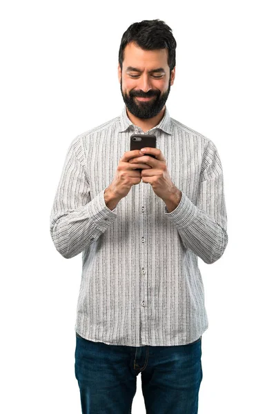 Schöner Mann mit Bart spricht mit Handy — Stockfoto